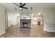 Open-concept living space with a cozy stone fireplace and modern flooring at 1201 Red Sunset Pl, Siler City, NC 27344
