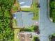 An aerial view of a home, showcasing its roof, landscaping, and proximity to the street and neighboring houses at 1408 Fairmont St, Durham, NC 27713