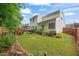 Manicured lawn and landscaping in the backyard with a patio and table at 1408 Fairmont St, Durham, NC 27713