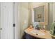 Bathroom with a framed mirror and a vanity with a tan countertop and oil rubbed bronze faucet at 1408 Fairmont St, Durham, NC 27713