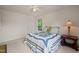 Well-lit bedroom showcasing a window, neutral carpet, door to hallway, and beautiful quilting on the bedspread at 1408 Fairmont St, Durham, NC 27713