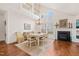 Dining area with a chandelier, fireplace, hardwood floors, and a view of the yard at 1408 Fairmont St, Durham, NC 27713