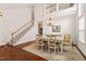 Spacious dining room featuring a large table, hardwood floors, and a view of the staircase at 1408 Fairmont St, Durham, NC 27713