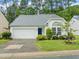 Charming one-story home with a manicured front lawn and attached two car garage at 1408 Fairmont St, Durham, NC 27713