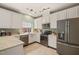 View of the Kitchen featuring stainless steel appliances, white cabinets and tile flooring at 1408 Fairmont St, Durham, NC 27713