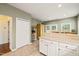 View of the Kitchen featuring ample natural light, white cabinets, and tile flooring at 1408 Fairmont St, Durham, NC 27713