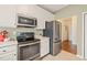 Functional kitchen with stainless steel appliances, white cabinets, and neutral countertops at 1408 Fairmont St, Durham, NC 27713