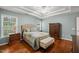 Main Bedroom features a tray ceiling, hardwood floors, and two windows at 1408 Fairmont St, Durham, NC 27713