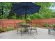 Backyard patio features a table, seating, and large umbrella at 1408 Fairmont St, Durham, NC 27713