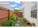 Landscaped side yard with stepping stones and a privacy fence creates a peaceful and inviting outdoor space at 1408 Fairmont St, Durham, NC 27713