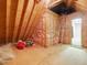 View of an attic with insulation, plywood flooring, and access ladder to a doorway at 1428 Gray Bluff Trl, Chapel Hill, NC 27517