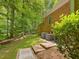 Spacious backyard featuring brick accents, mature trees, and two air conditioning units at 1428 Gray Bluff Trl, Chapel Hill, NC 27517