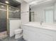 Updated bathroom features a shower with glass doors, tile surround, and a large mirror at 1428 Gray Bluff Trl, Chapel Hill, NC 27517