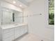 Bright bathroom boasts a white vanity with a large mirror and natural light from the window at 1428 Gray Bluff Trl, Chapel Hill, NC 27517