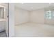Bright bedroom boasts neutral carpet, recessed lighting, and a view into the bathroom at 1428 Gray Bluff Trl, Chapel Hill, NC 27517