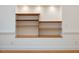 Charming built-in wooden shelves with recessed lighting, perfect for displaying decor at 1428 Gray Bluff Trl, Chapel Hill, NC 27517
