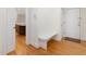 Entryway features wood floors and a built-in bench, leading to the kitchen at 1428 Gray Bluff Trl, Chapel Hill, NC 27517