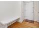 Inviting entryway with a built-in bench and hardwood floors, leading to a white front door at 1428 Gray Bluff Trl, Chapel Hill, NC 27517