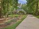 Charming brick two-story home with a lush green lawn and mature trees at 1428 Gray Bluff Trl, Chapel Hill, NC 27517