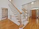 Welcoming foyer with elegant staircase and wood flooring at 1428 Gray Bluff Trl, Chapel Hill, NC 27517