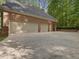 Large three-car garage showcasing durable brick construction and ample parking at 1428 Gray Bluff Trl, Chapel Hill, NC 27517