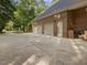 Spacious three-car garage with a brick exterior and ample parking space at 1428 Gray Bluff Trl, Chapel Hill, NC 27517
