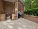 Brick construction around back of house with fenced area and mature bushes at 1428 Gray Bluff Trl, Chapel Hill, NC 27517