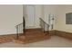 Staircase leading to a door in the garage with black railing and water heater at 1428 Gray Bluff Trl, Chapel Hill, NC 27517