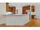 Open kitchen layout with a breakfast bar, stainless steel appliances, and hardwood floors at 1428 Gray Bluff Trl, Chapel Hill, NC 27517