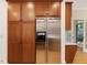 Kitchen with stainless steel refrigerator and ample storage provided by the rich wood cabinetry at 1428 Gray Bluff Trl, Chapel Hill, NC 27517