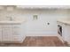 Clean laundry room with tile floors, white cabinets, utility sink and appliance hookups for washer and dryer at 1428 Gray Bluff Trl, Chapel Hill, NC 27517