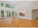 Bright living room with hardwood floors, built-in shelves, and floor to ceiling windows at 1428 Gray Bluff Trl, Chapel Hill, NC 27517