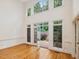 Bright and airy living room with hardwood floors, a wall of windows and door to patio at 1428 Gray Bluff Trl, Chapel Hill, NC 27517
