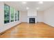 Bright living room with large windows and a cozy fireplace at 1428 Gray Bluff Trl, Chapel Hill, NC 27517