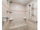 Tiled shower featuring multiple showerheads, a built-in bench, and safety handrails at 1428 Gray Bluff Trl, Chapel Hill, NC 27517
