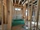 Unfinished bathroom showcasing exposed wooden framing, pipes, and a green bathtub at 1521 Sunrise Ave, Raleigh, NC 27608