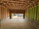 Unfinished garage with wooden framing and concrete flooring at 1521 Sunrise Ave, Raleigh, NC 27608