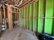 An interior room under construction with exposed wooden framing and green moisture barrier at 1521 Sunrise Ave, Raleigh, NC 27608