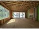 Large, unfinished room with exposed framing, windows, sliding doors, and a fireplace at 1521 Sunrise Ave, Raleigh, NC 27608