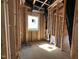 An unfinished room with exposed framing, a window, and black ventilation tubes at 1521 Sunrise Ave, Raleigh, NC 27608
