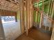 View of unfinished room with exposed wooden framing, stairs, and cinder block at 1521 Sunrise Ave, Raleigh, NC 27608