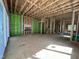 Spacious unfinished room with exposed wooden framing, stairs, and a fireplace at 1521 Sunrise Ave, Raleigh, NC 27608