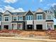 New construction townhomes featuring modern design elements and attached garages at 158 Ripple Way # 321, Clayton, NC 27520