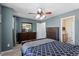 Bedroom with dark wood furniture, a ceiling fan, and an en-suite bathroom at 1710 Grace Point Rd, Morrisville, NC 27560