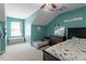 A carpeted bedroom space with a pitched ceiling, a bed, and a window seat at 1710 Grace Point Rd, Morrisville, NC 27560