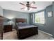 A cozy bedroom featuring a ceiling fan, a window, and an inviting bed at 1710 Grace Point Rd, Morrisville, NC 27560