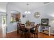Elegant dining room with a wooden table set for six, a stylish chandelier, and hardwood flooring at 1710 Grace Point Rd, Morrisville, NC 27560