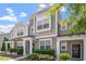 Inviting townhome with neutral siding, white trim, and a well-maintained front yard with lush greenery at 1710 Grace Point Rd, Morrisville, NC 27560