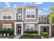 Charming townhome with stone and siding, featuring a welcoming front porch and manicured landscaping at 1710 Grace Point Rd, Morrisville, NC 27560