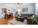 Comfortable living room with hardwood floors, a plush gray sectional, and a stylish coffee table at 1710 Grace Point Rd, Morrisville, NC 27560